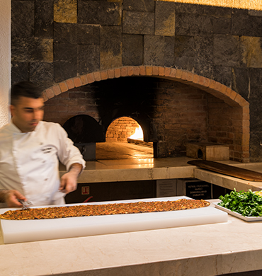 Turkish Chef Cooking Lahmacun At Hillside Beach Club